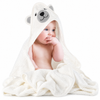 Baby wrapped in a cream bear hooded towel